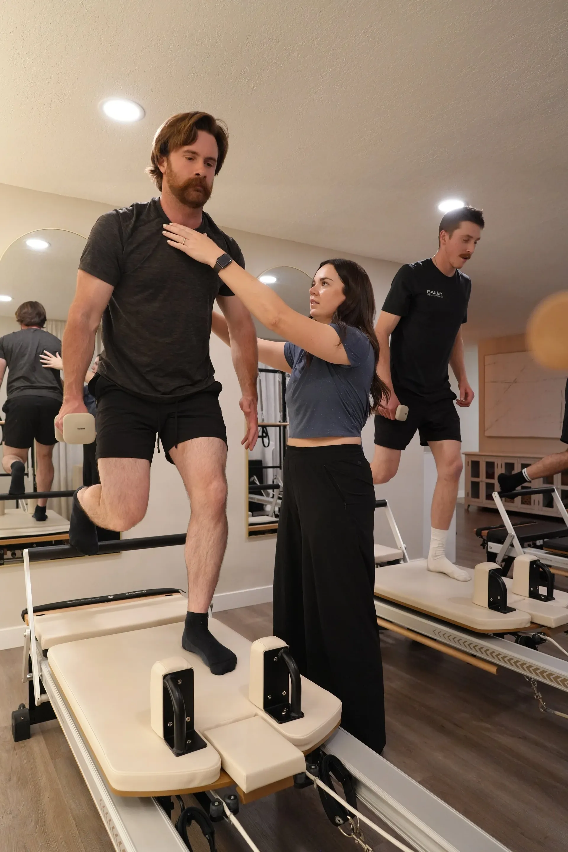 A Reformer Pilates class in session
